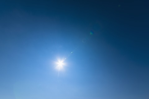 Blue sky lit with bright sunshine.
