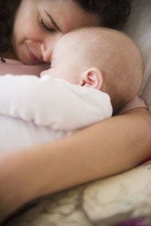 Mother and baby boy (2-5 months) sleeping together . Photo : Jamie Grill