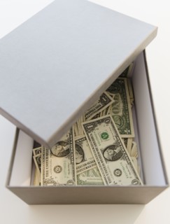 Box full of dollar banknotes. Photo: Jamie Grill