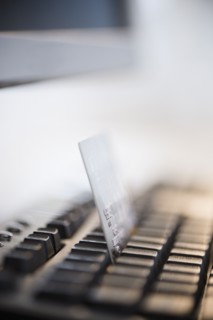Close-up shot of computer keyboard and credit card. Photo : Jamie Grill