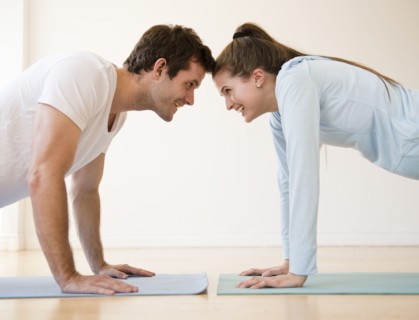 Happy young couple exercising together. Photo : Jamie Grill