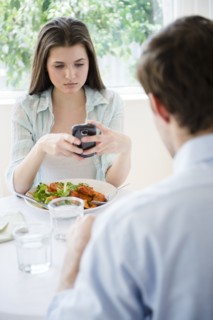 Yung woman texting over meal . Photo : Jamie Grill