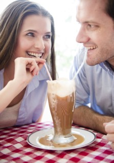 Happy young couple drinking milk shake . Photo : Jamie Grill