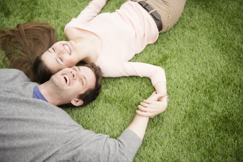 Couple relaxing on grass. Photo : Jamie Grill