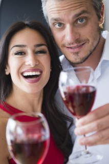 Couple toasting with red wine. Photo : Jamie Grill