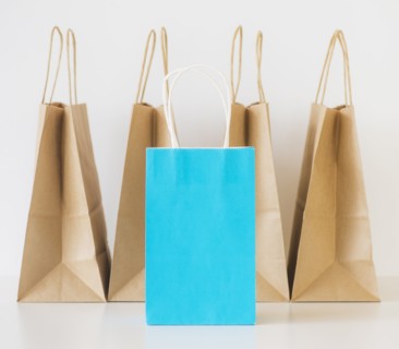 Studio shot of shopping bags and note book. Photo : Daniel Grill