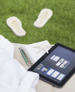 Digital tablet and notebook on lounger. Photo: Daniel Grill