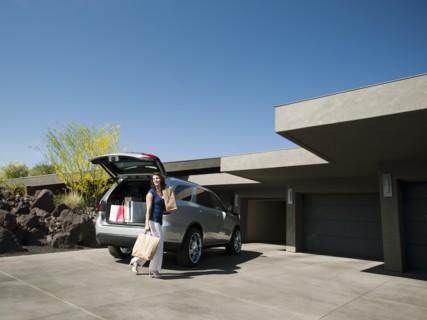 Woman with groceries leaving car.