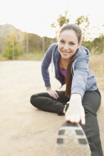 Woman exercising on dusty track. Photo : Sarah M. Golonka
