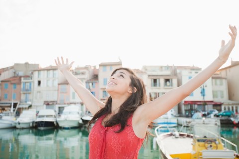 France, Cassis, Portrait of young woman with arms spread. Photo: Mike Kemp