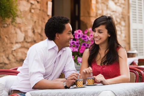 France, Cassis, Couple sitting in cafe drinking coffee. Photo: Mike Kemp