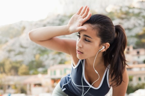 France, Marseille, Young woman in tracksuit and with headphones. Photo : Mike Kemp