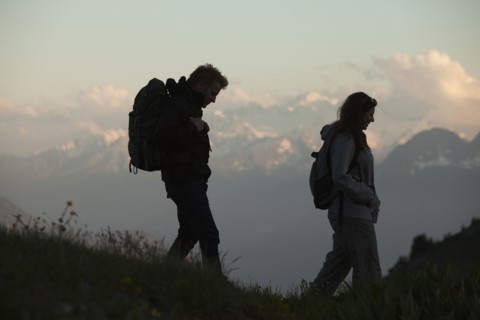Switzerland, Leysin, Hikers marching through Alpine landscape. Photo : Mike Kemp