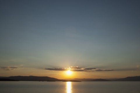 USA, Montana, Flathead Lake, View of sunset over lake. Photo: Noah Clayton