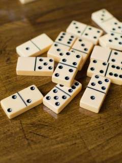 Domino tiles on wooden surface, studio shot. Photo: Jessica Peterson