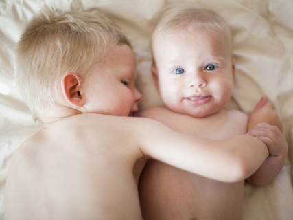 Portrait of boy (2-3) with baby sister (6-11 months). Photo: Jessica Peterson
