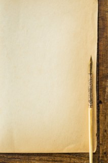 Old brown paper with fountain pen, studio shot.