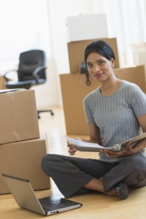 Businesswoman reading documents in new office.