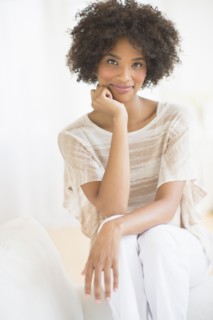Portrait of woman sitting on sofa.