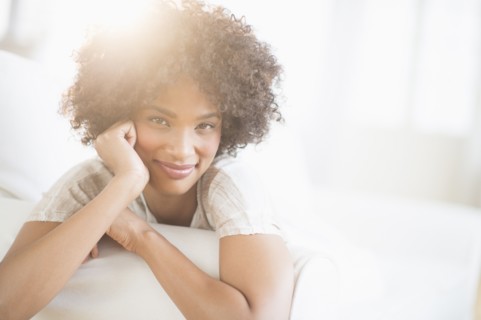 Portrait of woman relaxing on sofa.