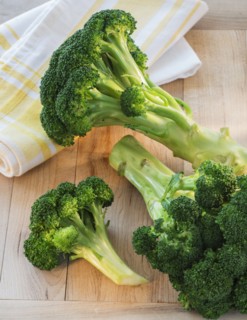 Broccoli on cutting board, studio shot.