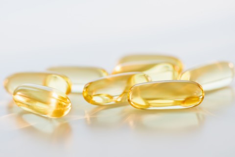 Omega fatty acid pills on white background, studio shot.