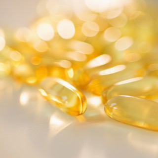 Omega fatty acid pills on white background, studio shot.