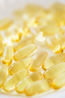 Omega fatty acid pills on white background, studio shot.