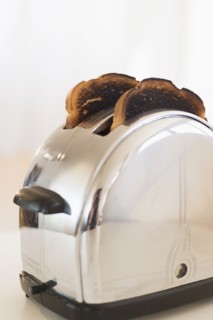 Burnt toasts in toaster.