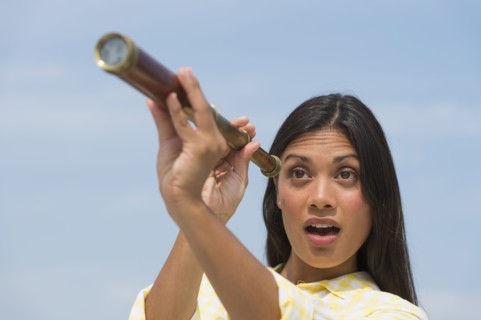 Woman looking through telescope.