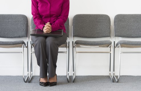 Woman sitting in waiting room.