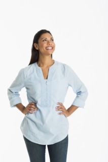 Studio shot of young woman smiling.