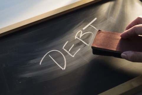 Close up of woman's hand over chalk board.