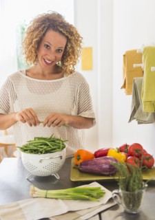 Young woman preparing food in kitchen.