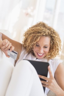 Young woman e-shopping with digital tablet.