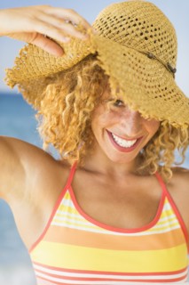 Portrait of smiling young woman in sun hat.