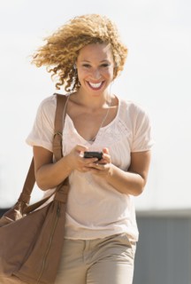 Young woman walking with headphones.
