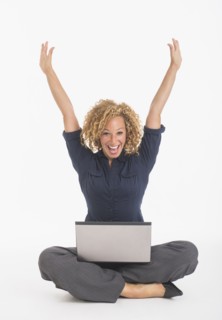 Portrait of happy young woman with laptop, studio shot.
