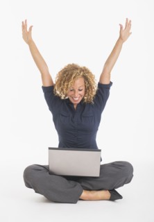 Portrait of happy young woman with laptop, studio shot.