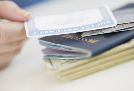 Close up of woman's hand holding Social Security Card.