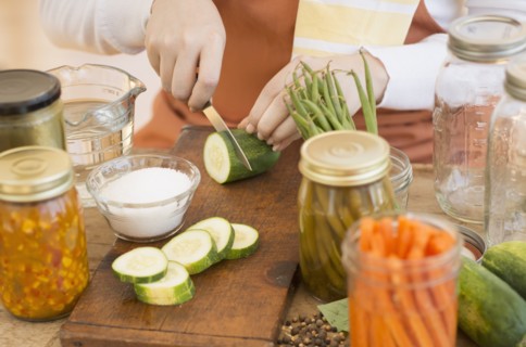 Woman preparing vegetables to preserve it.