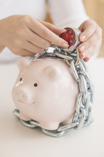 Piggybank closed with chain and combination lock.