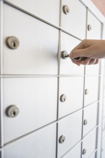 Woman opening safety deposit box.