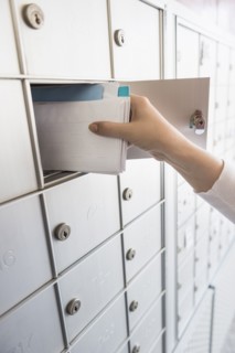 Woman taking letters from safety deposit box.