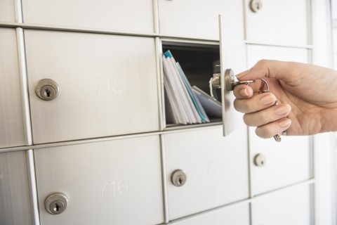 Woman closing safety deposit box.