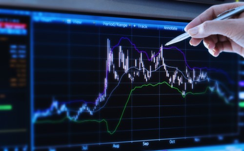 Studio shot of woman pointing at chart.