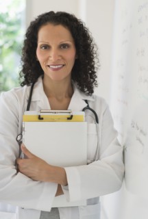 Portrait of doctor standing in office.
