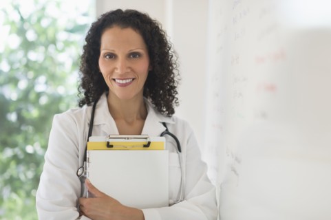 Portrait of doctor standing in office.