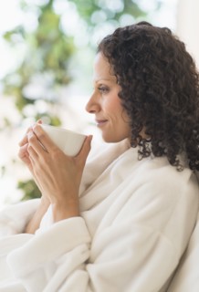 Woman relaxing with cup of coffee.