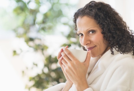 Woman relaxing with cup of coffee.